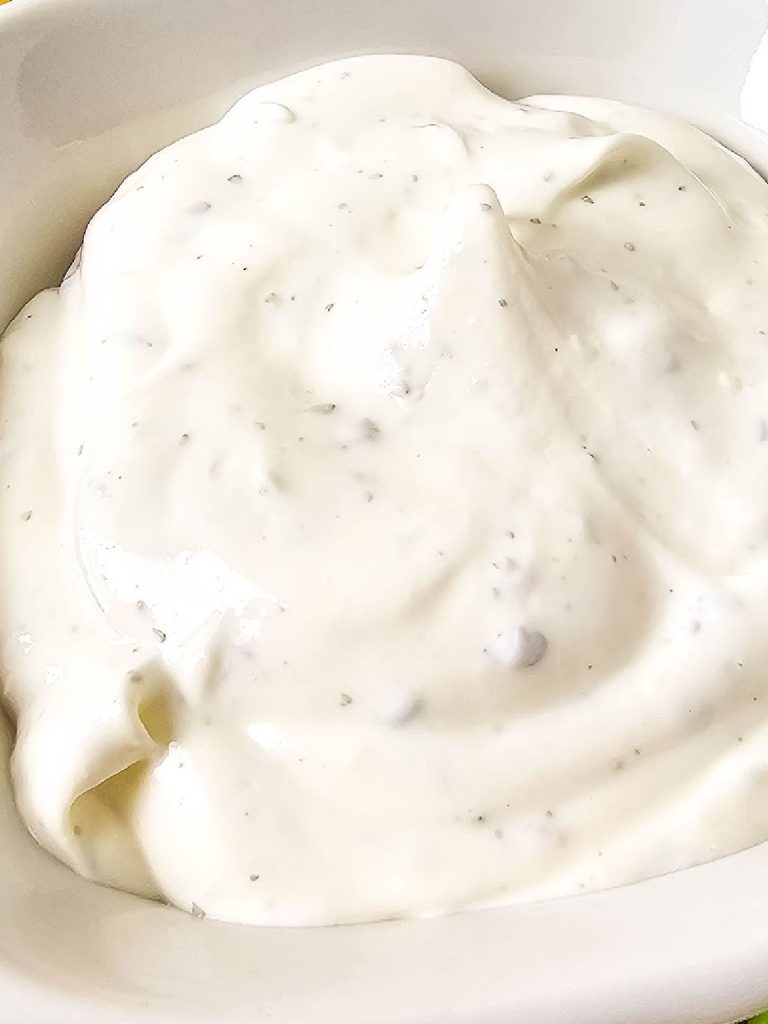 Mixed sour cream and ranch dip in a bowl.