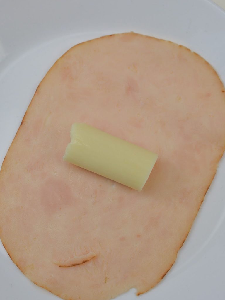 Cheese stick on a slice of deli turkey.