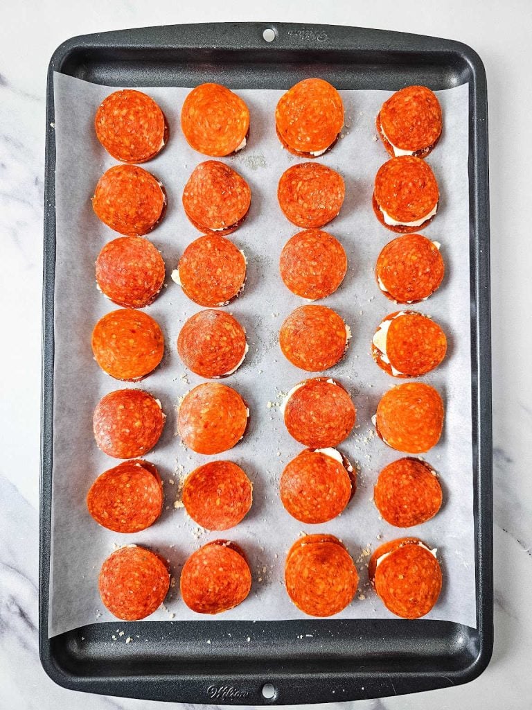 Cream cheese pepperoni bites on a baking sheet.