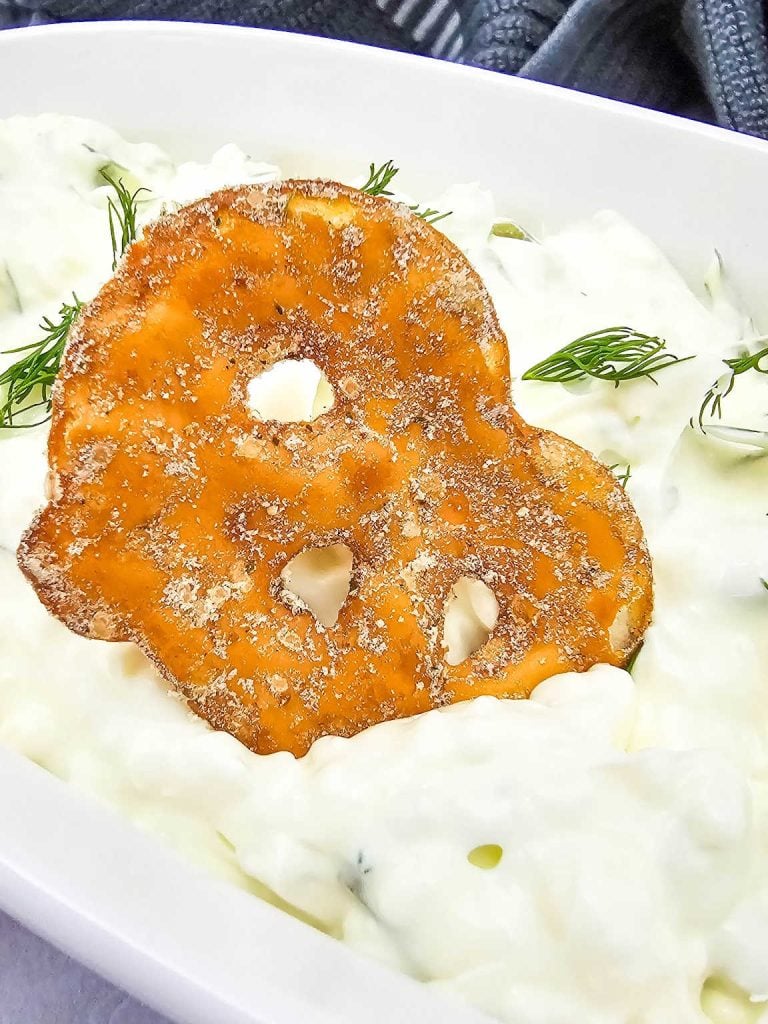 Cracker dipped in dill pickle dip.