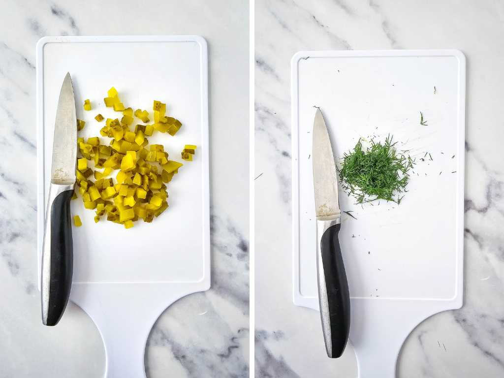 Chopped pickle and fresh dill, knives on white cutting boards.