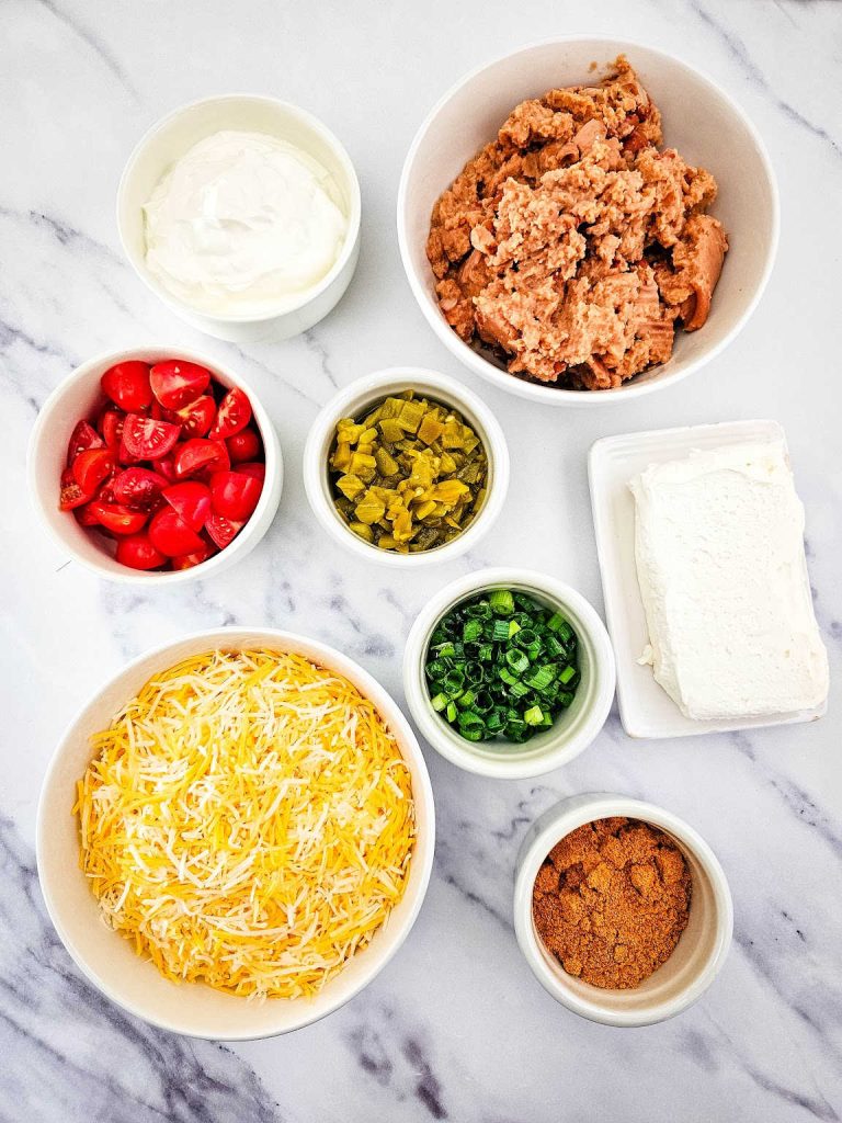 Iron skillet Texas trash dip ingredients.