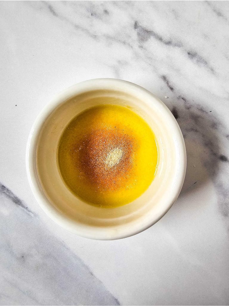Melted butter and garlic powder in a bowl.