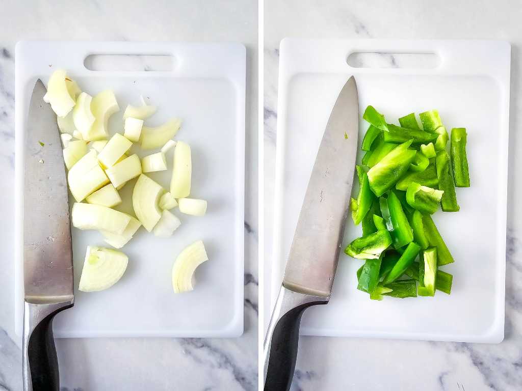 Chopped onion and bell pepper and knives on white cutting boards.