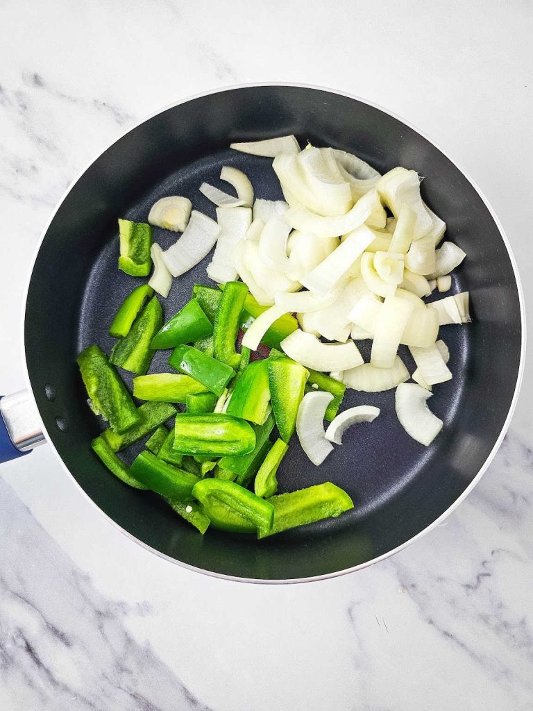 Onion and green pepper in a skillet.