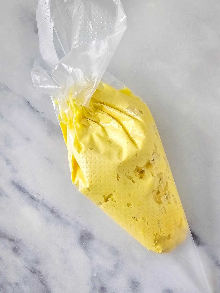 Egg yolk mixture in a pipping bag.