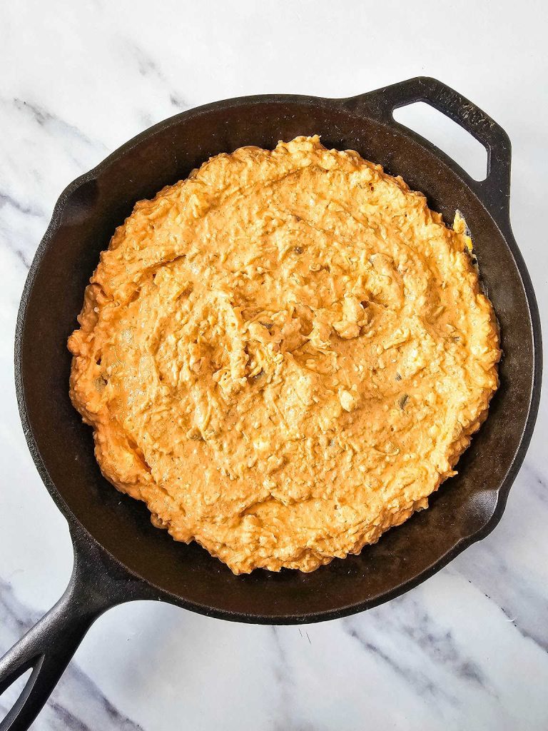 Texas trash dip mixture in a skillet.