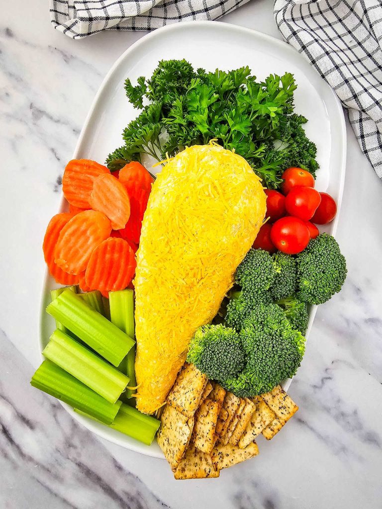 Easter carrot cheese ball and vegetables on a serving platter.