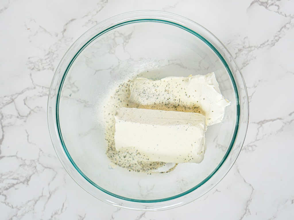 Cheese and ranch seasoning in a mixing bowl.