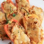 BBQ stuffed mini peppers on a white plate.