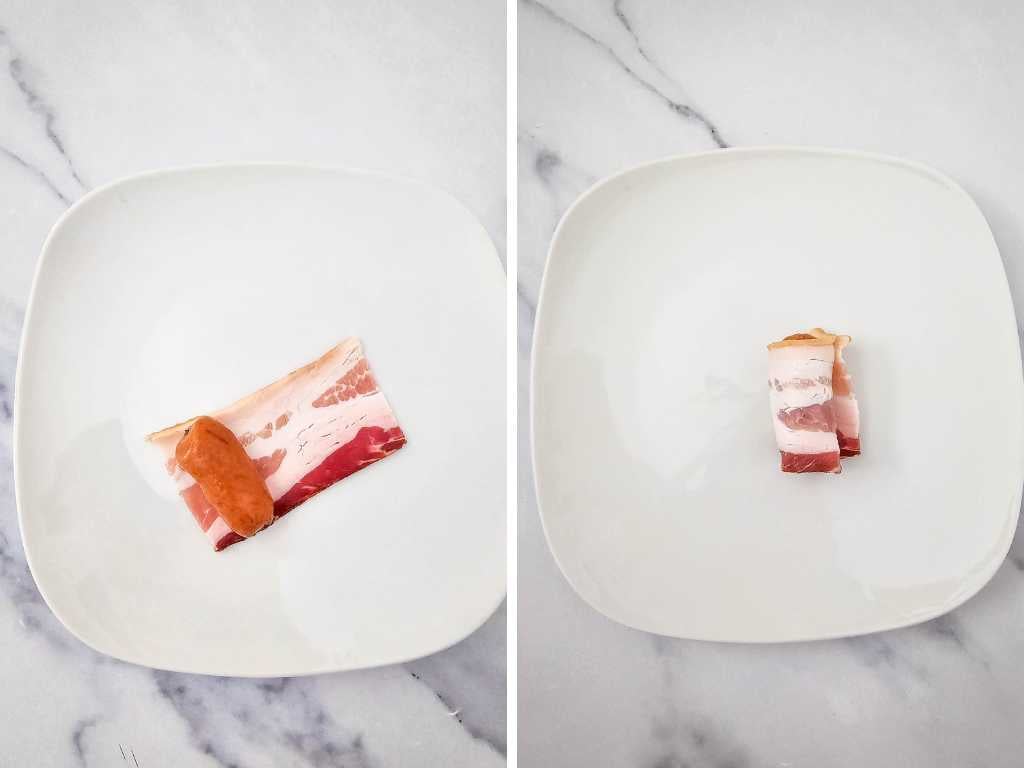 A slice of bacon and bacon wrapped smokie on white plates.