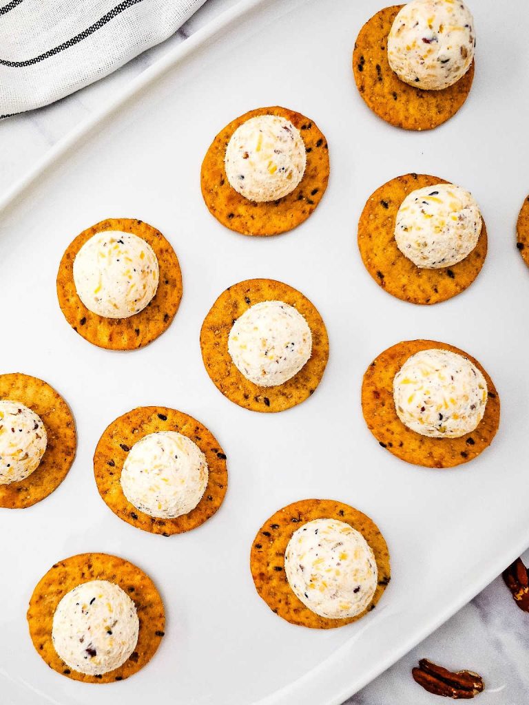 Cheeseball bites on a white platter.